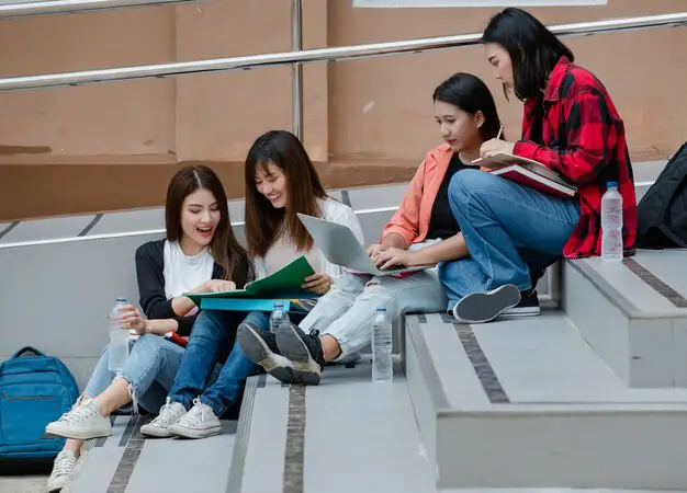 group-four-attractive-asian-college-students-sitting-down-each-staircases-university-campus-studying-outdoor-concept-education-friendship-college-students-life