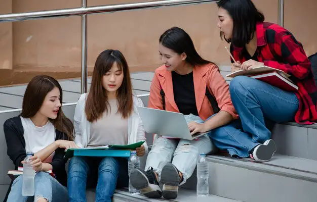 group-four-attractive-asian-college-students-sitting-down-each-staircases-university-campus-studying-outdoor-concept-education-friendship-college-students-life